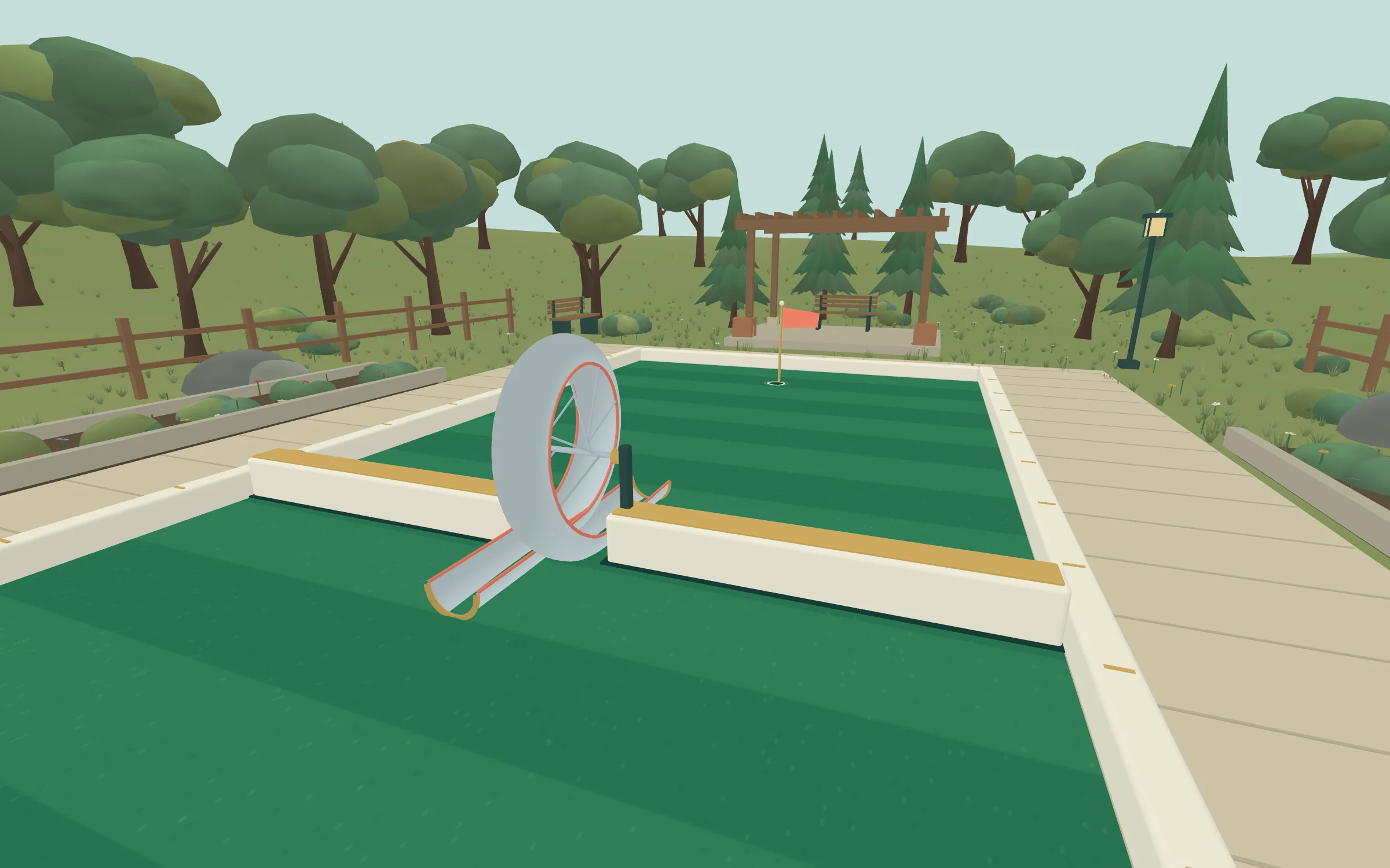 The loop hole of the RoadVR minigolf course, with a steel loop between two rails and the flag beyond